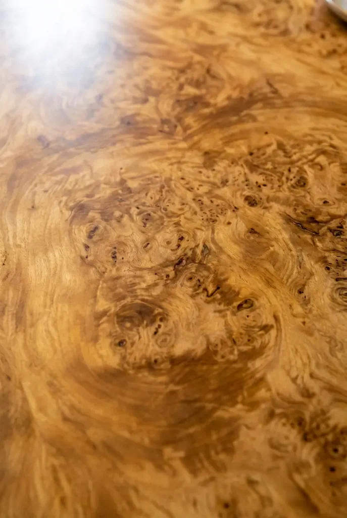 modern burl wood dining tables feature high-quality veneer over engineered wood rather than solid burl